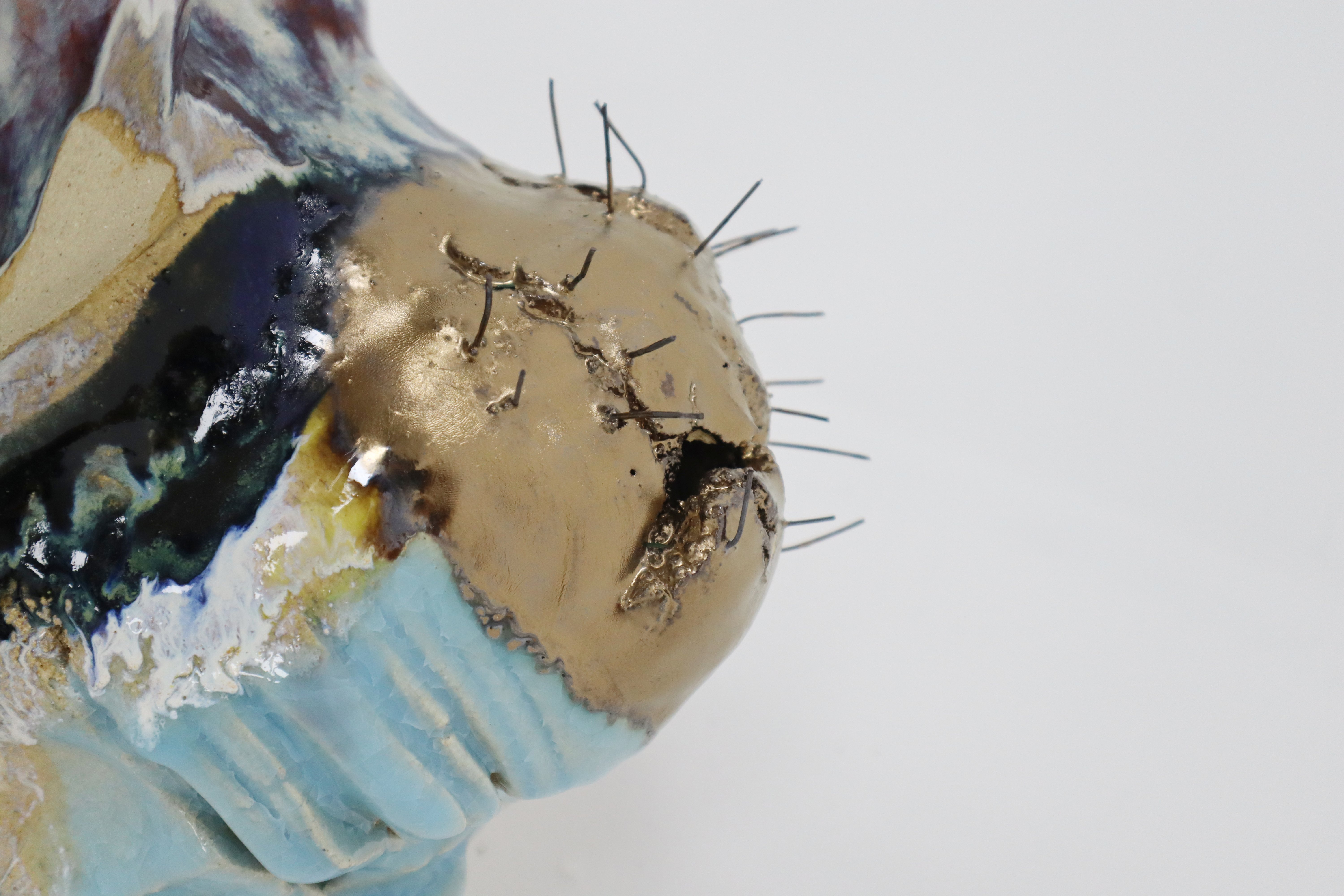 Self VI detail — wire stitching and gold glaze